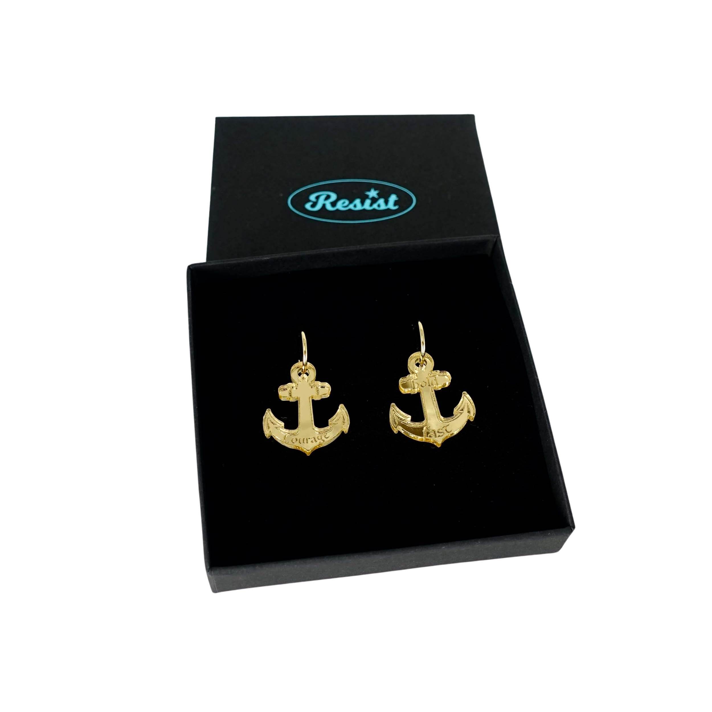 Medium anchor earrings in gold mirror etched with the words 'courage' on one and 'hold fast' on the other. Shown in a Wear and Resist gift box.