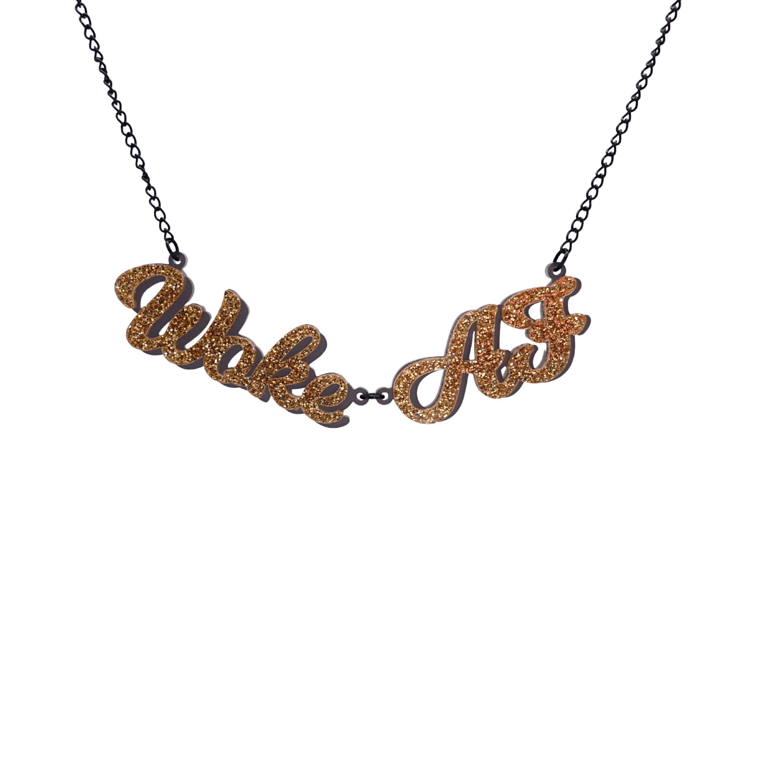 Woke AF necklace in gold glitter shown hanging against a white background.