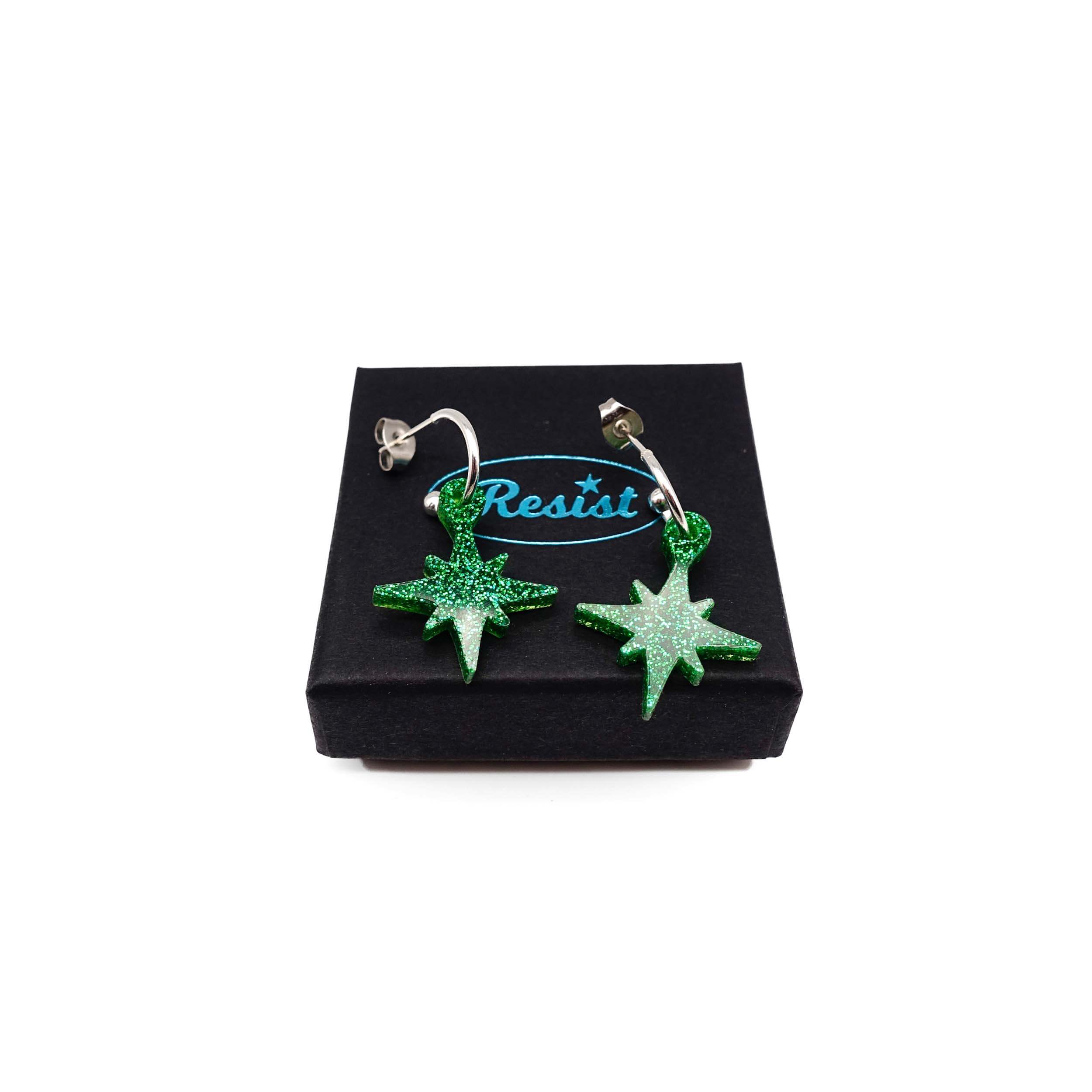 Green glitter limited edition Festive Vintage Star earrings, shown on a Wear and Resist gift box.