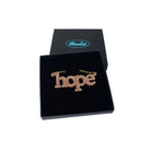 Hope necklace in pink fizz glitter shown in a Wear and Resist gift box.