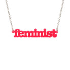 Hot pink  Feminist necklace shown hanging on a white background.