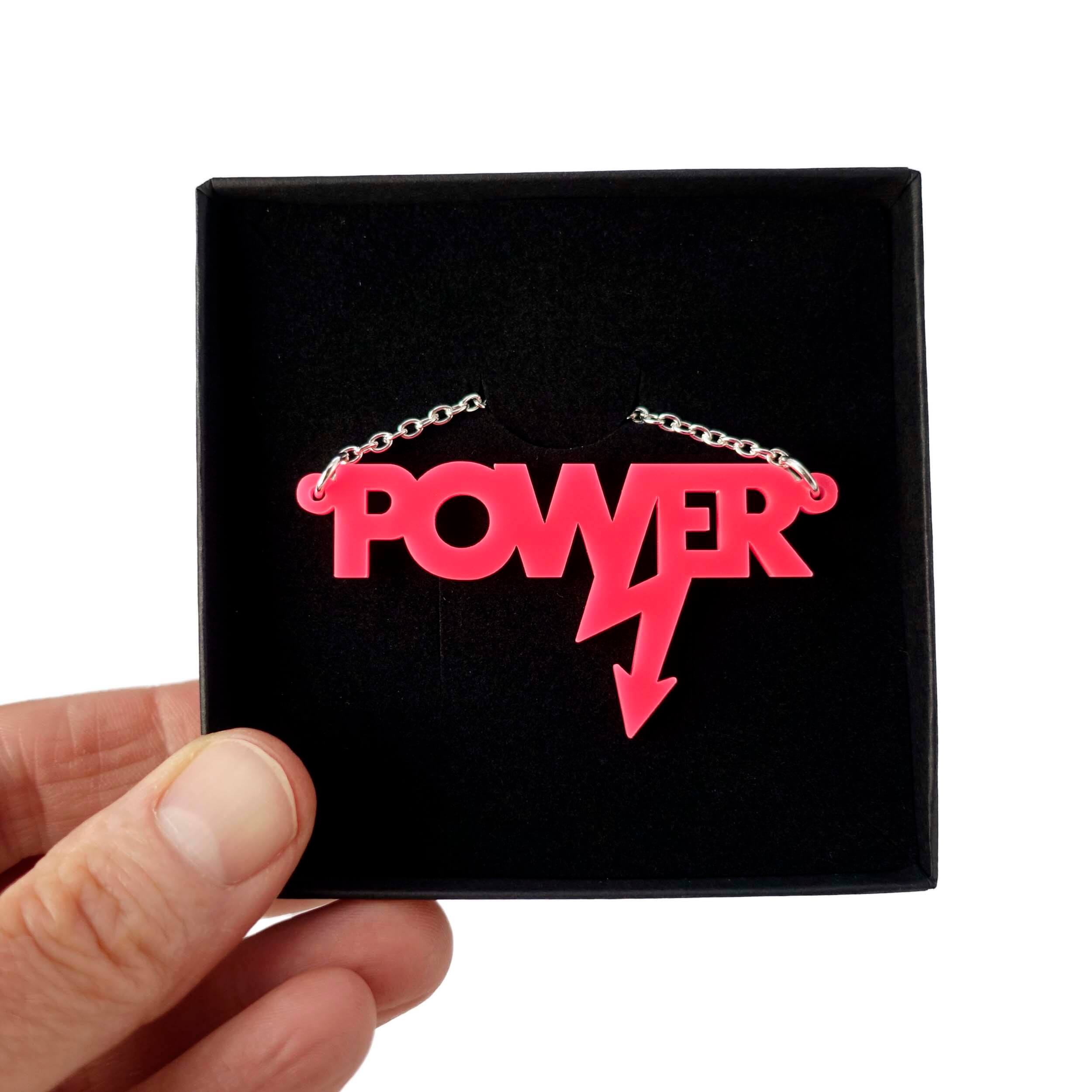 Mini power necklace in hot pink shown in a Wear and Resist gift box.