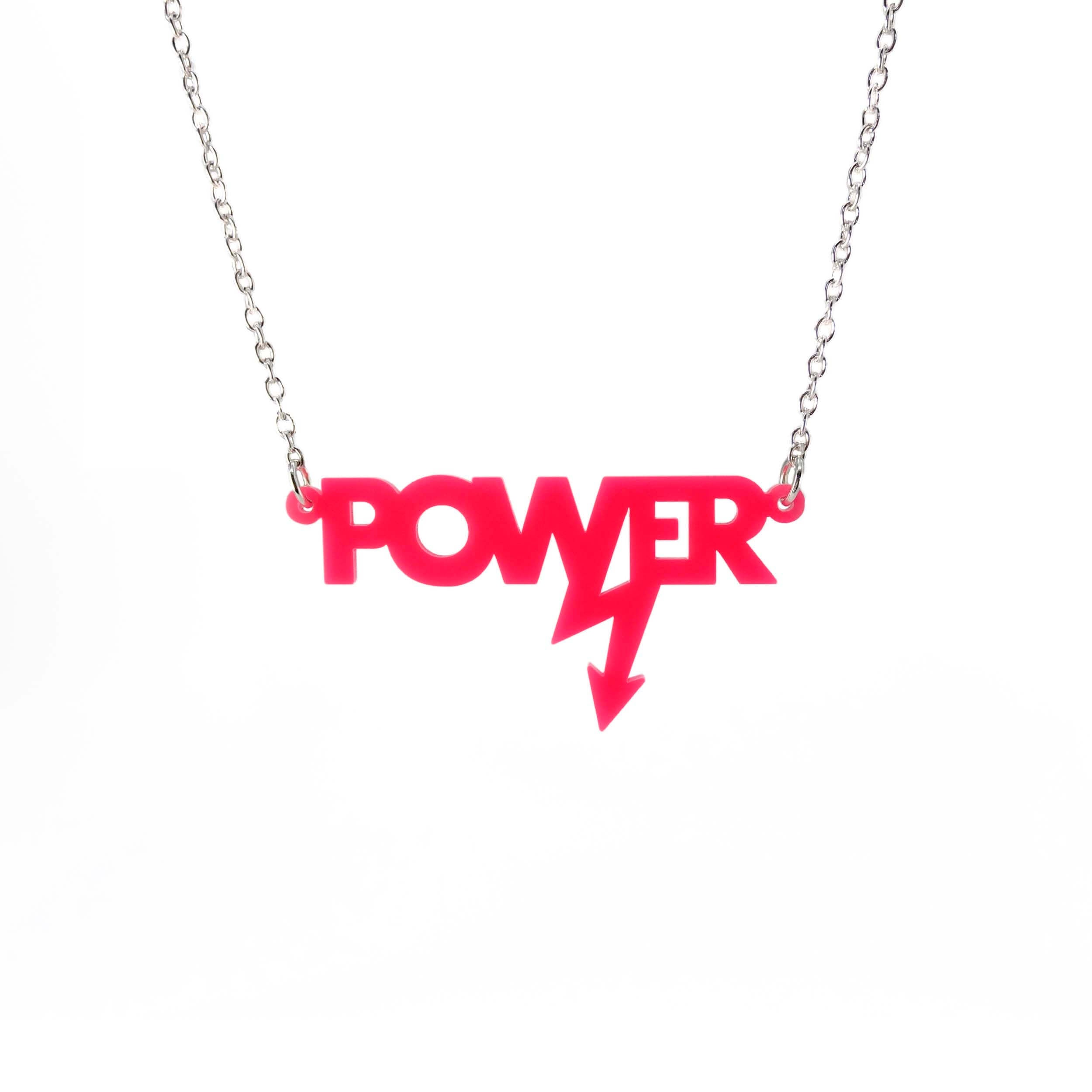 Mini power necklace in hot pink shown hanging on a silver chain against a white background. Designed in collaboration with Mary Beard for her book Women and Power.