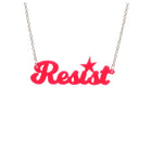 A 'Resist' necklace in hot pink shown hanging against a white background. background.