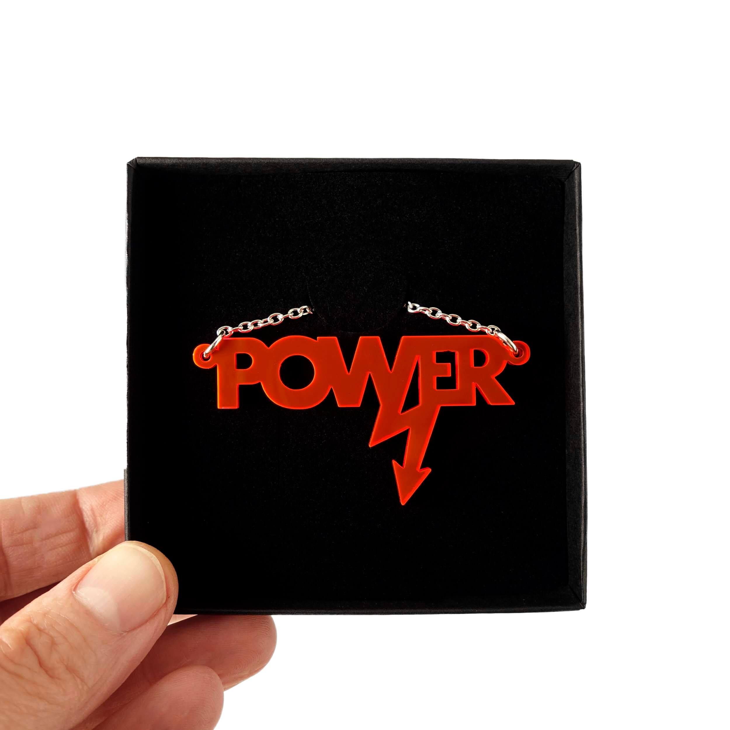 Mini power necklace in hot red shown in a Wear and Resist gift box.