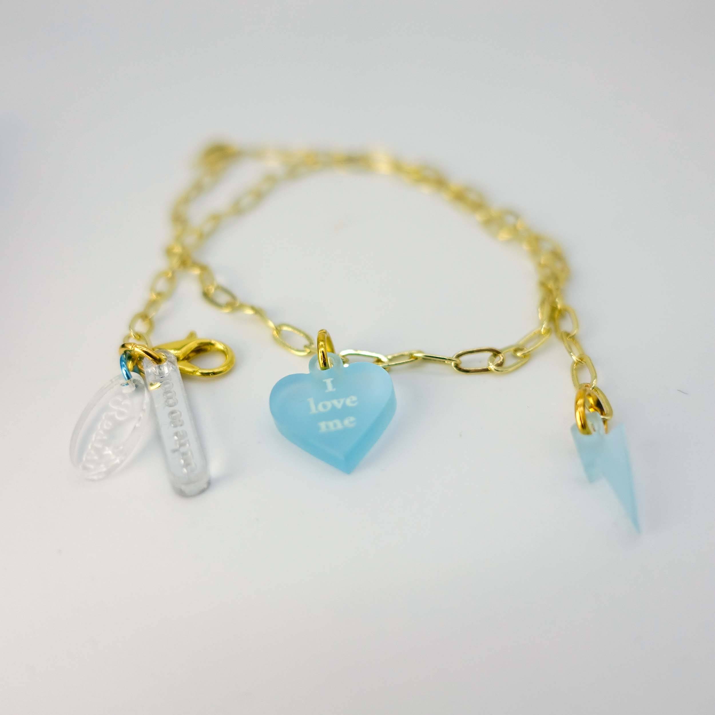 I love me glow in the dark choker and bracelet on gold delicate paperclip chain, shown on a white background. 