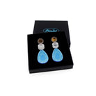 Large Belle Époque Jewel drop earrings in Cool Sky: sky blue, silver and bronze colours shown in a Wear and Resist gift box.