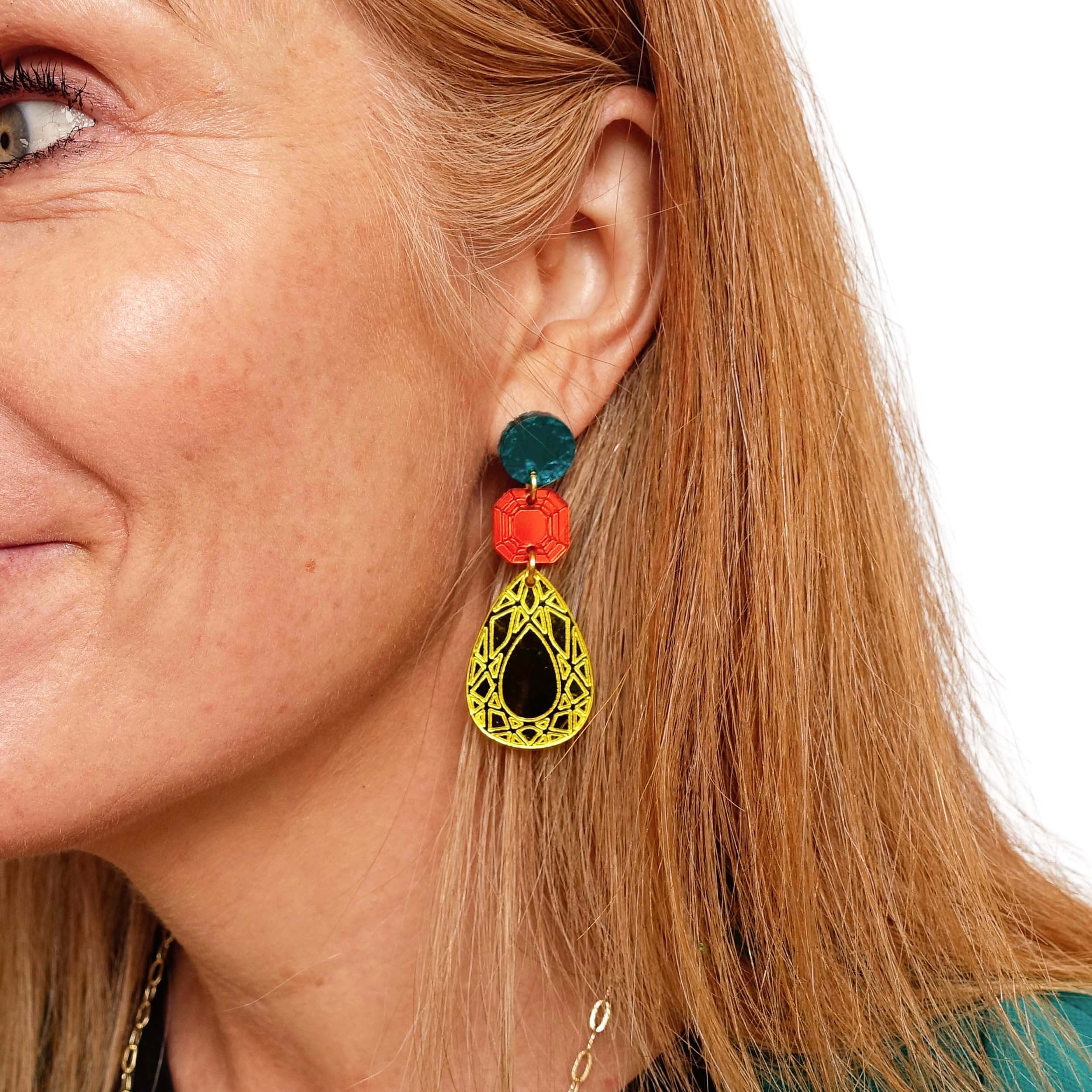 Sarah Day wears Belle Époque Jewel drop earrings in Flame Mambo: yellow, flame and teal colours.  