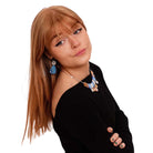 Eliza wears large Belle Époque Jewel drop earrings in Cool Sky with a necklace from the Austerity Jewels collection.