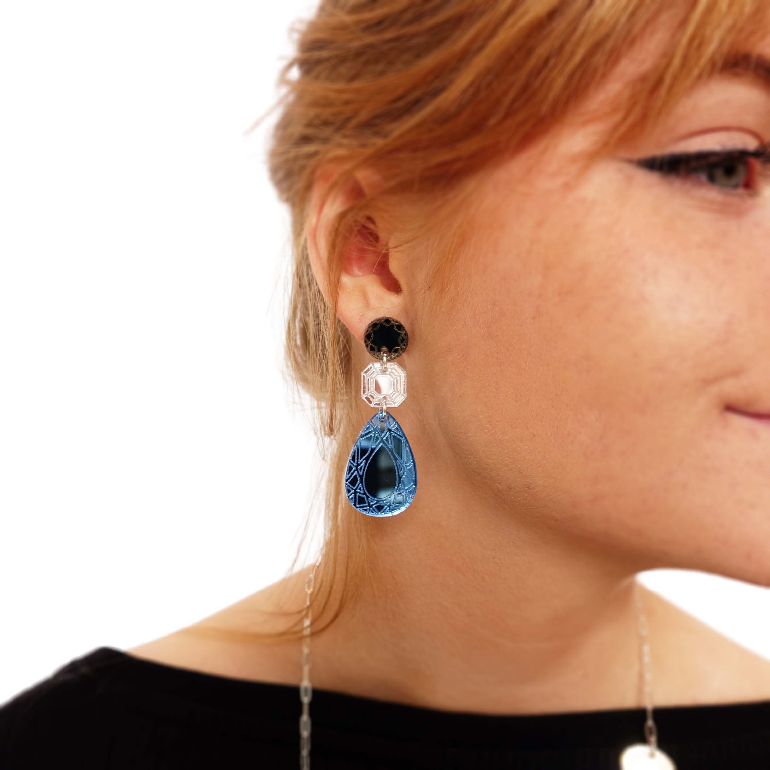 Eliza wears Large Belle Époque Jewel drop earrings in Cool Sky: sky blue, silver and bronze colours.  