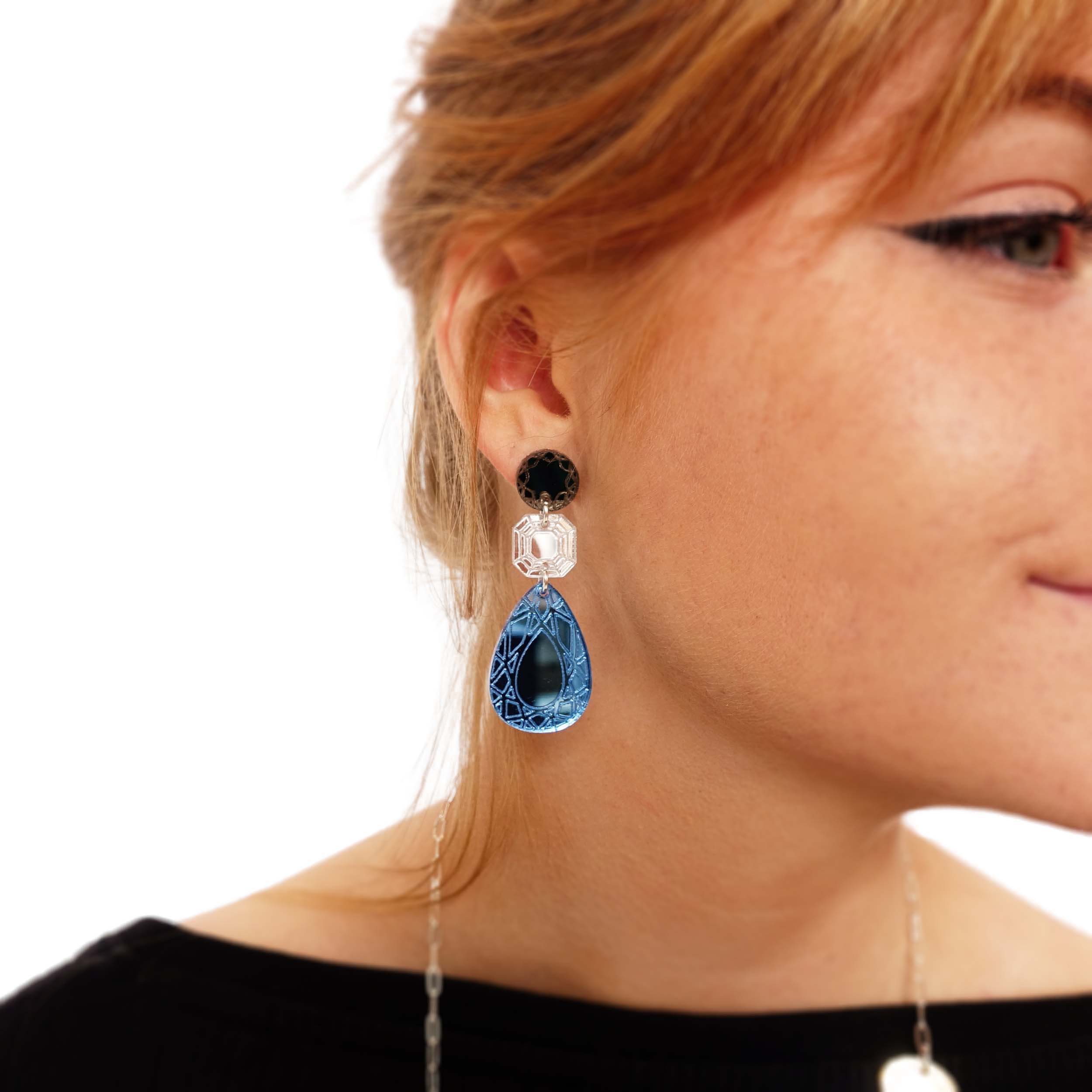 Eliza wears Large Belle Époque Jewel drop earrings in Cool Sky: sky blue, silver and bronze colours.