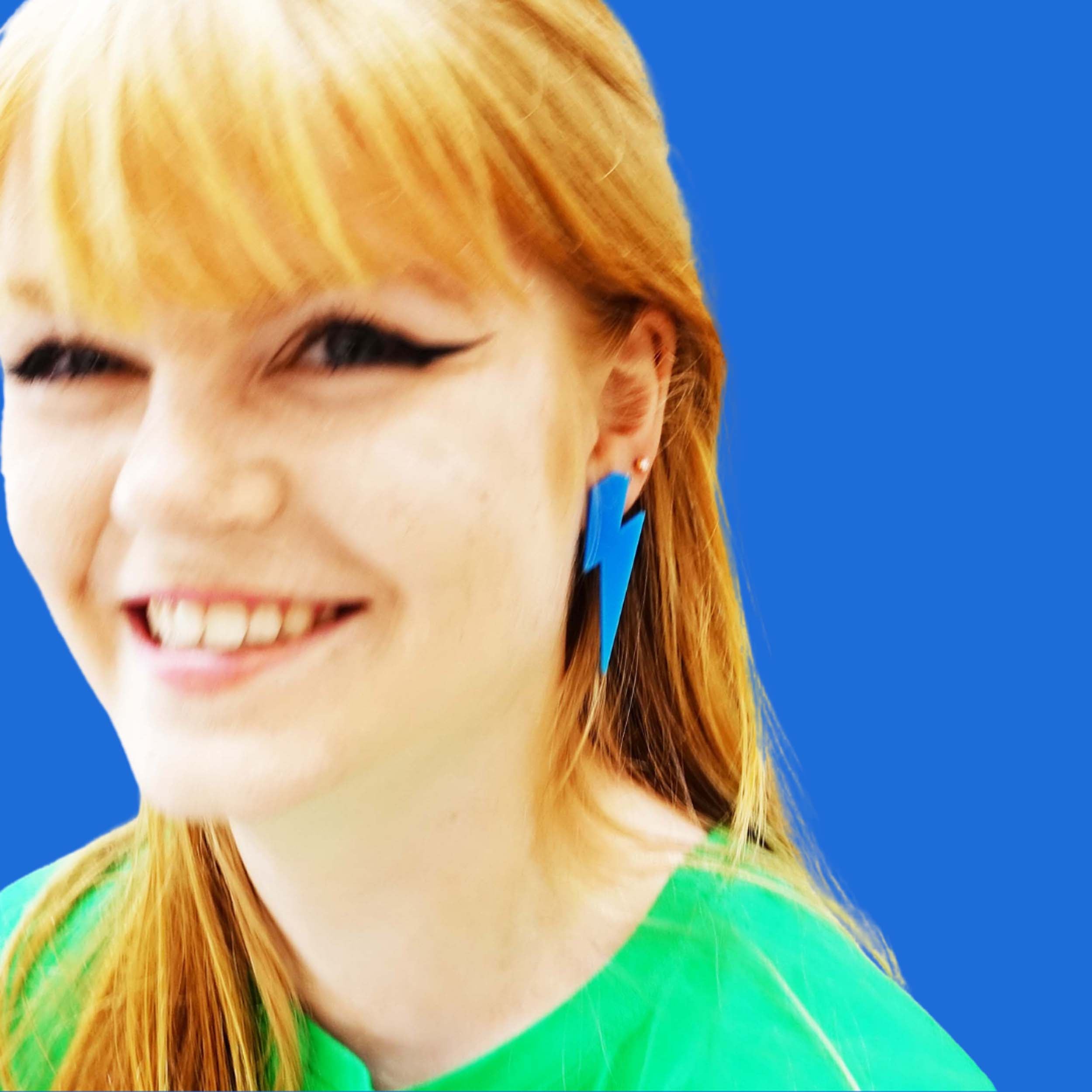 Eliza wears large Lightning Bolt earrings in Matisse Blue.