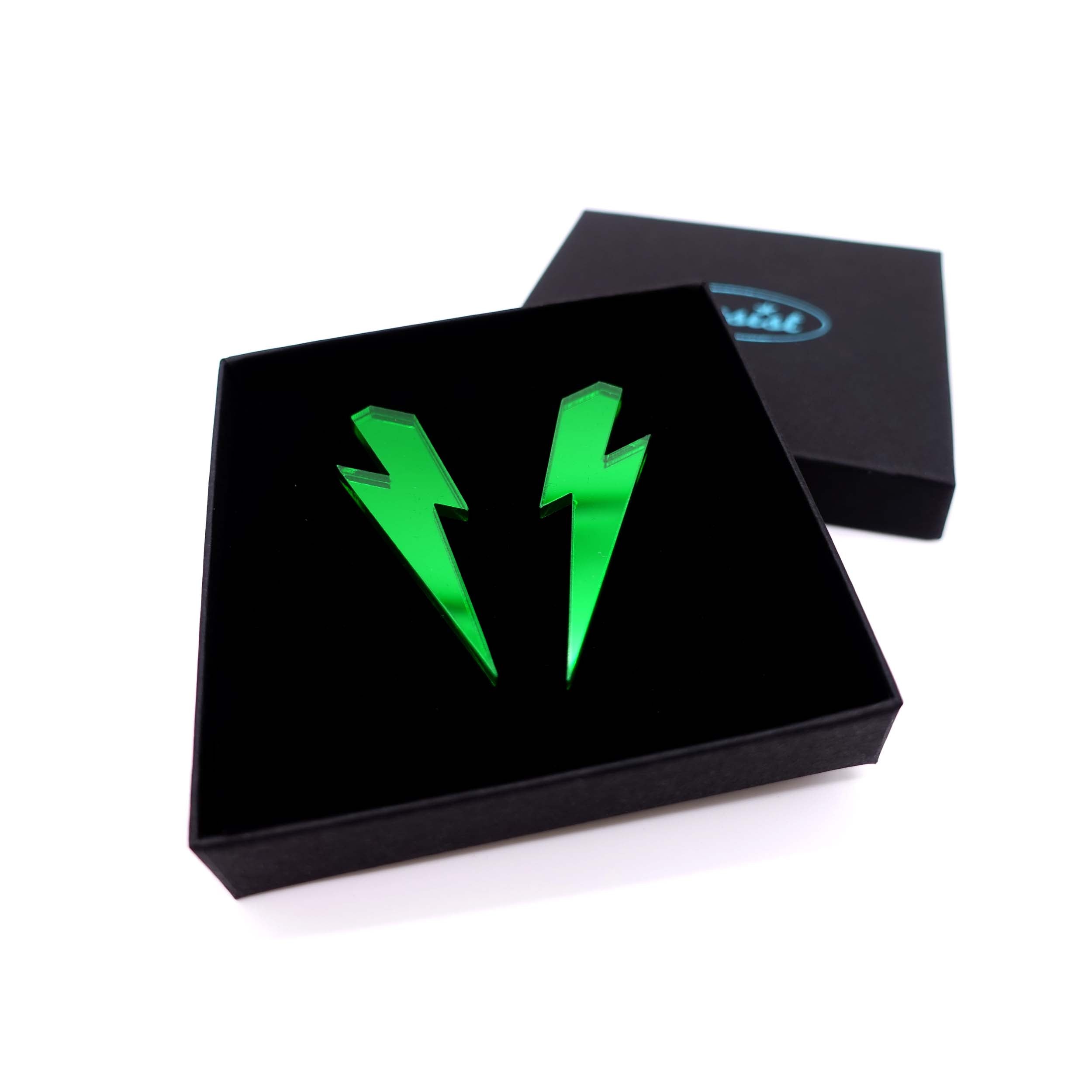 Large Lightning Bolt earrings in envy green mirror, shown in a Wear and Resist gift box.