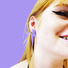 Eliza wears large Lightning Bolt earrings in parma violet.