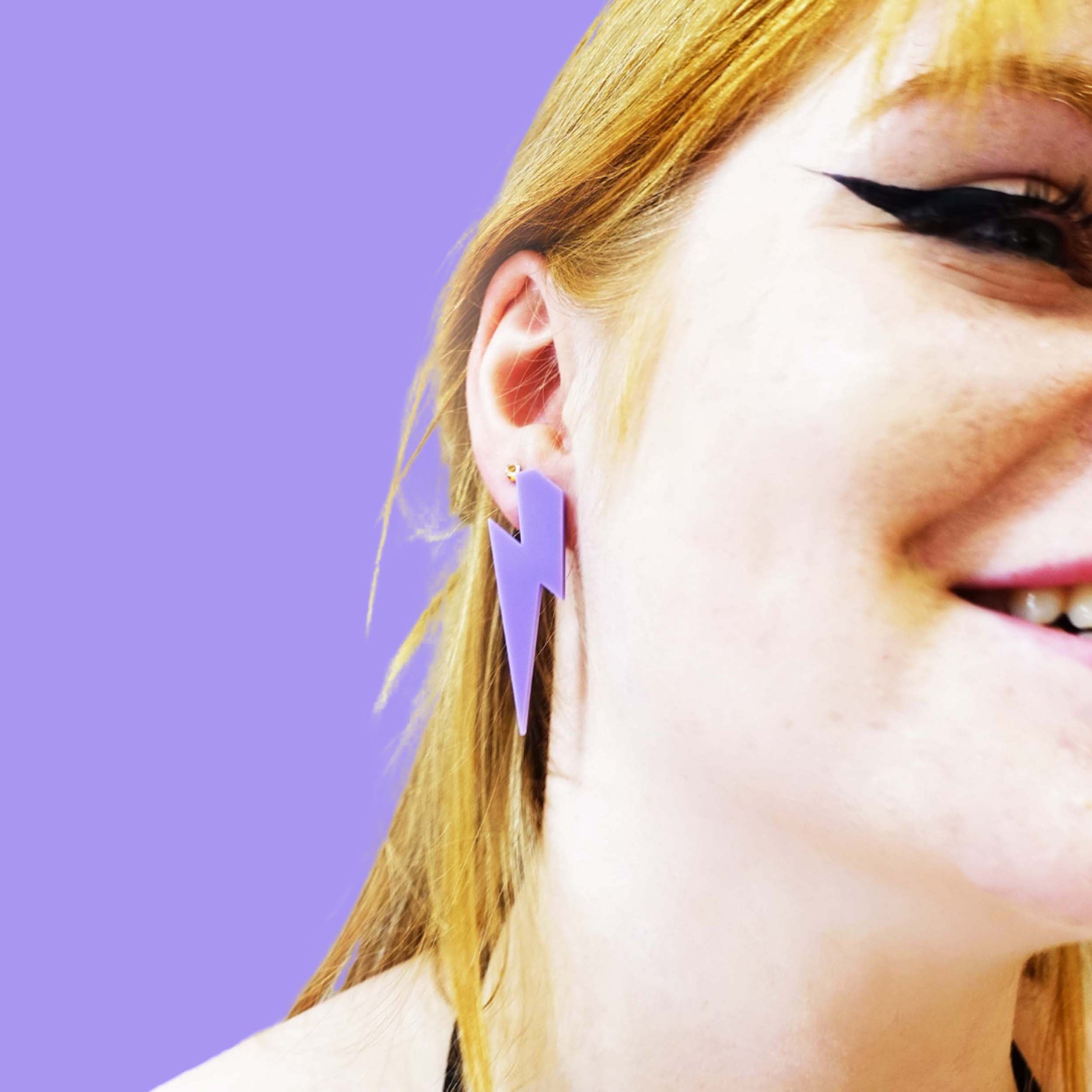 Eliza wears large Lightning Bolt earrings in parma violet.