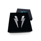 Large Lightning Bolt earrings in silver glitter, shown in a Wear and Resist gift box.