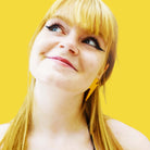 Eliza wears large Lightning Bolt earrings in sunflower yellow.