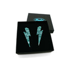 Large Lightning Bolt earrings in teal glitter, shown in a Wear and Resist gift box.
