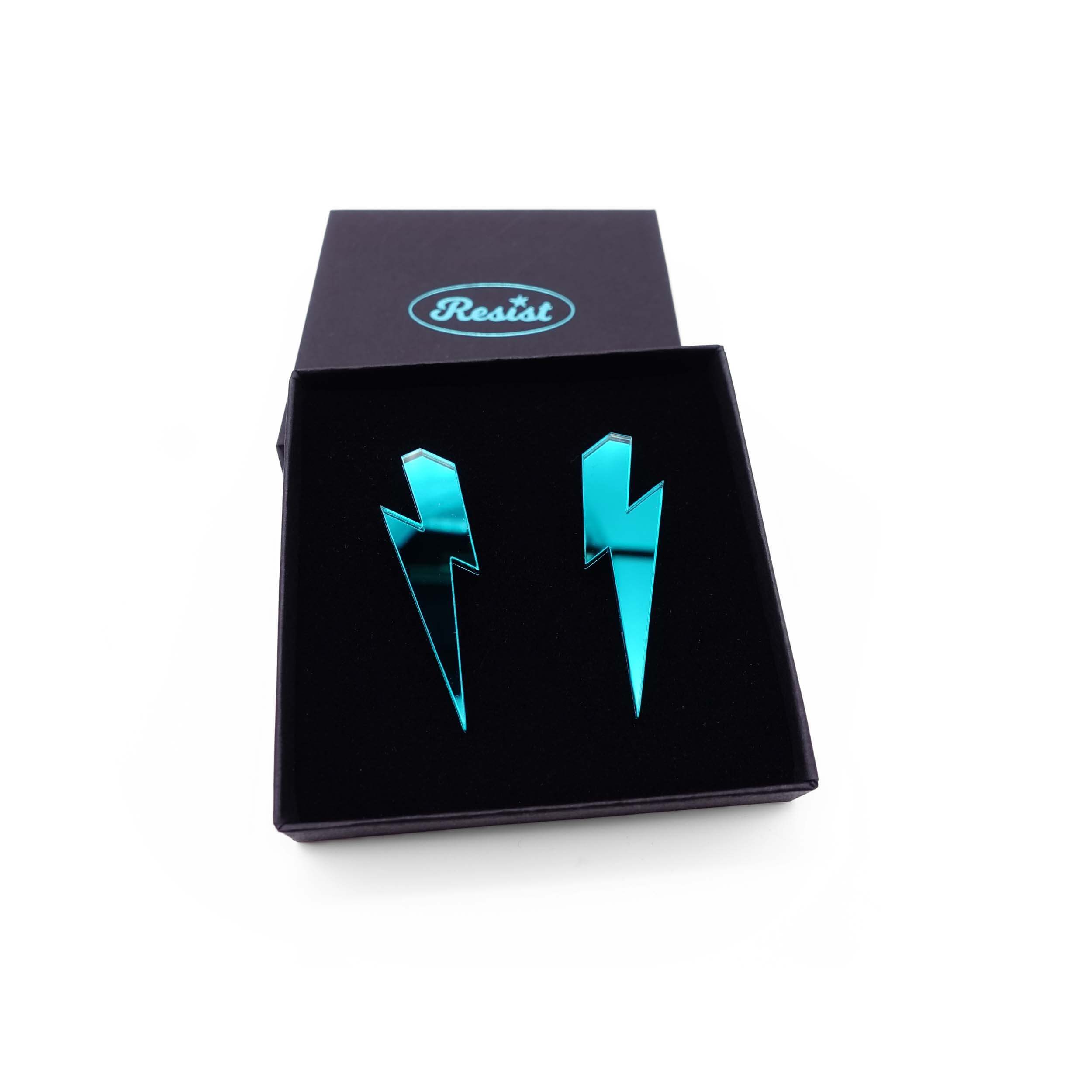 Large Lightning Bolt earrings in teal mirror, shown in a Wear and Resist gift box.