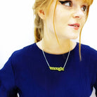 Eliza wears Enough necklace in matte lemon.