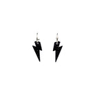 Lightning bolt hoop earrings in black glitter on silver-plated hoops, shown hanging against a white background.