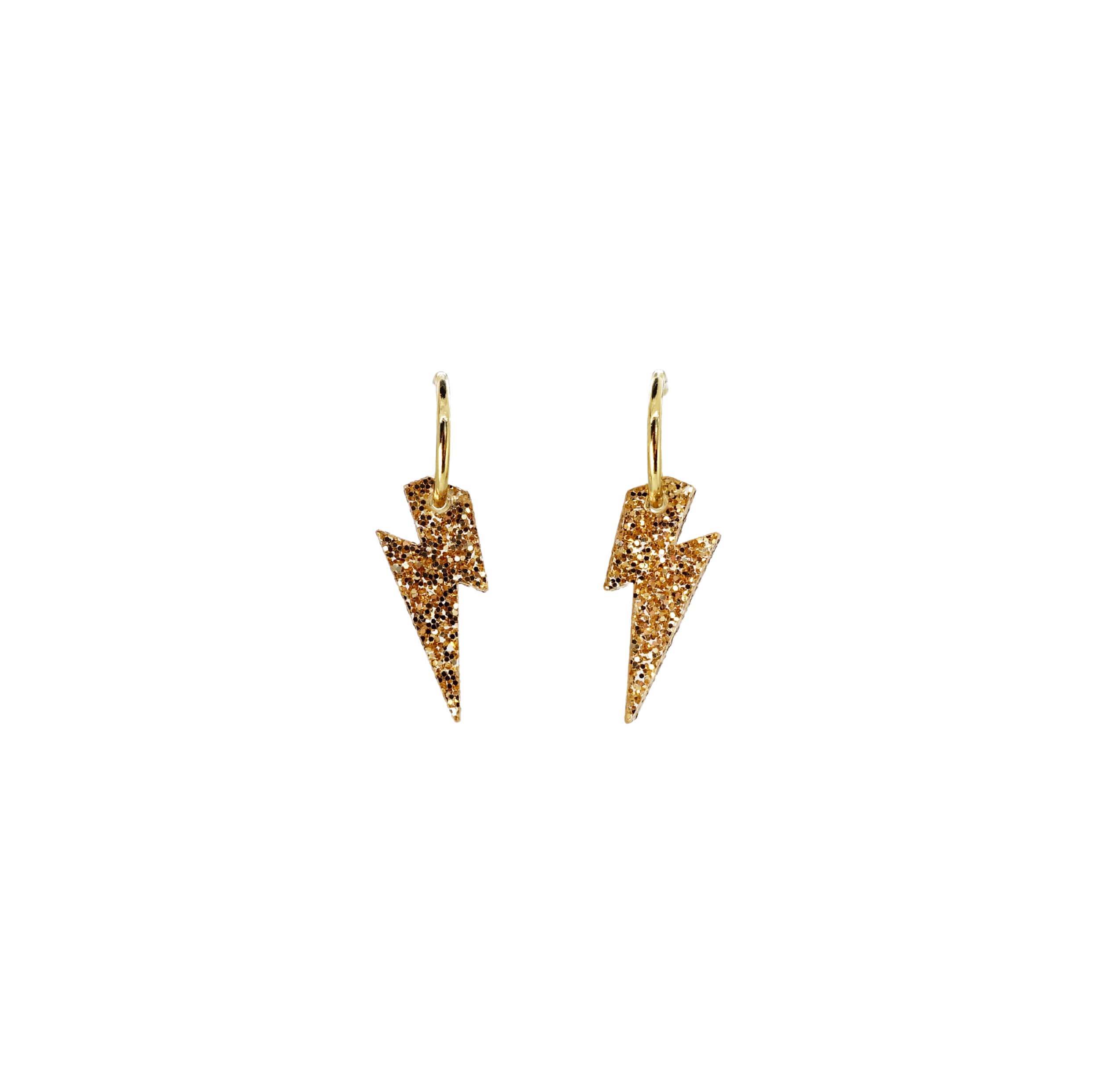 Lightning bolt hoop earrings in gold glitter on gold-plated hoops shown hanging against a white background.