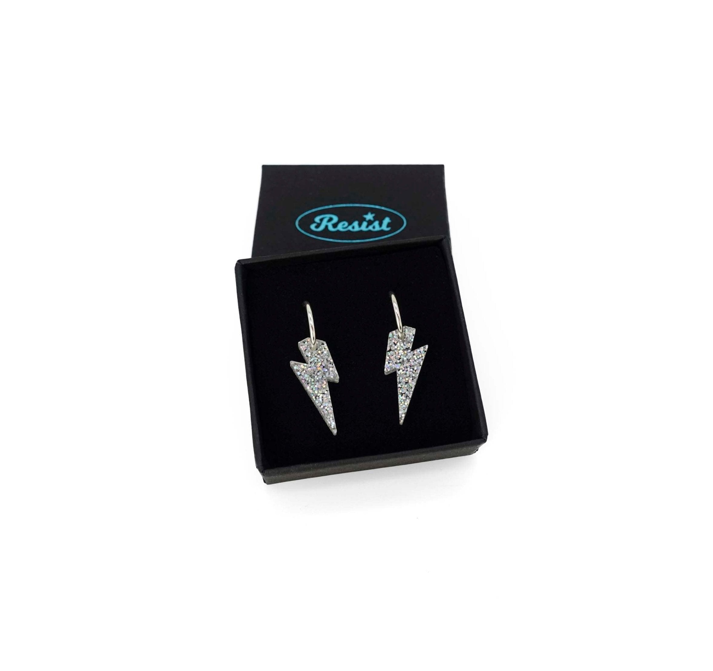 Lightning bolt hoop earrings in silver glitter on silver-plated hoops, shown  in a small Wear and Resist gift box.