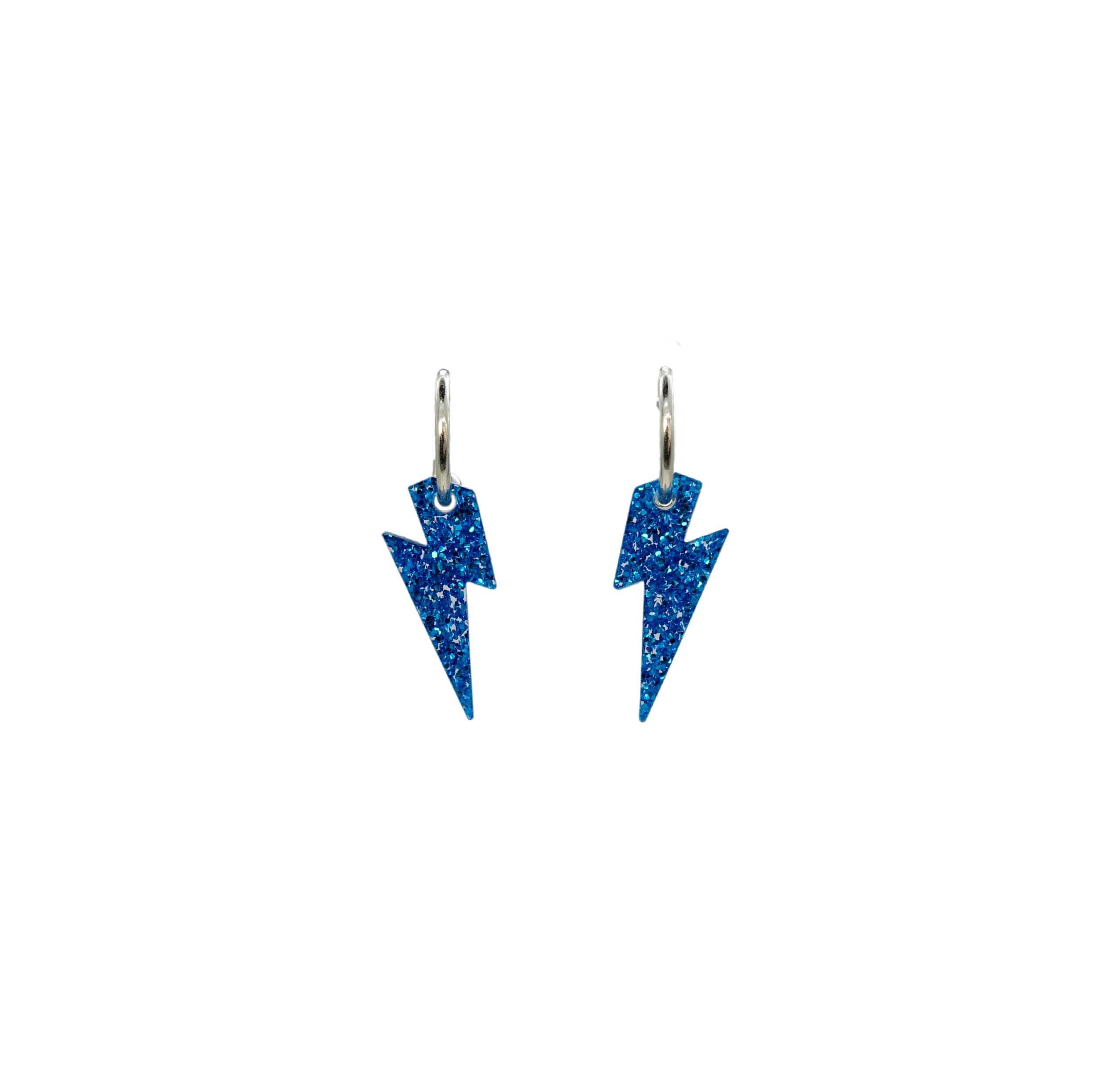 Lightning bolt hoop earrings in blue glitter on silver-plated hoops, shown hanging against a white background.