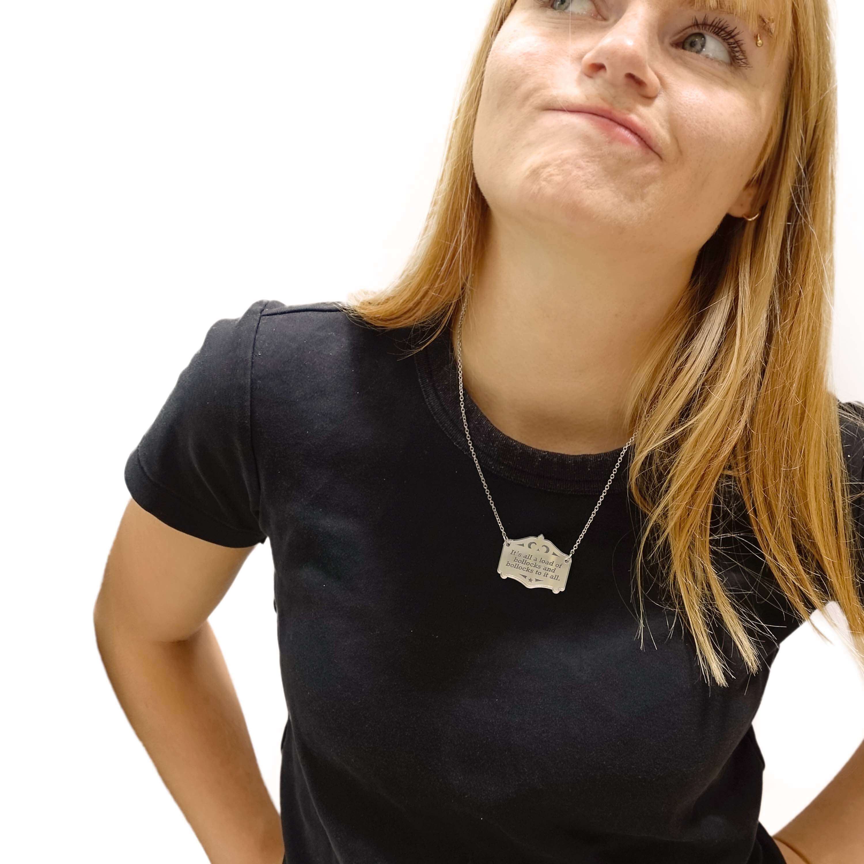 Eliza wears a silver It's all a load of bollocks and bollocks to it all necklace on a stainless steel chain.