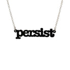 Matte black Persist necklace in typewriter font hanging on a silver chain against a white background.