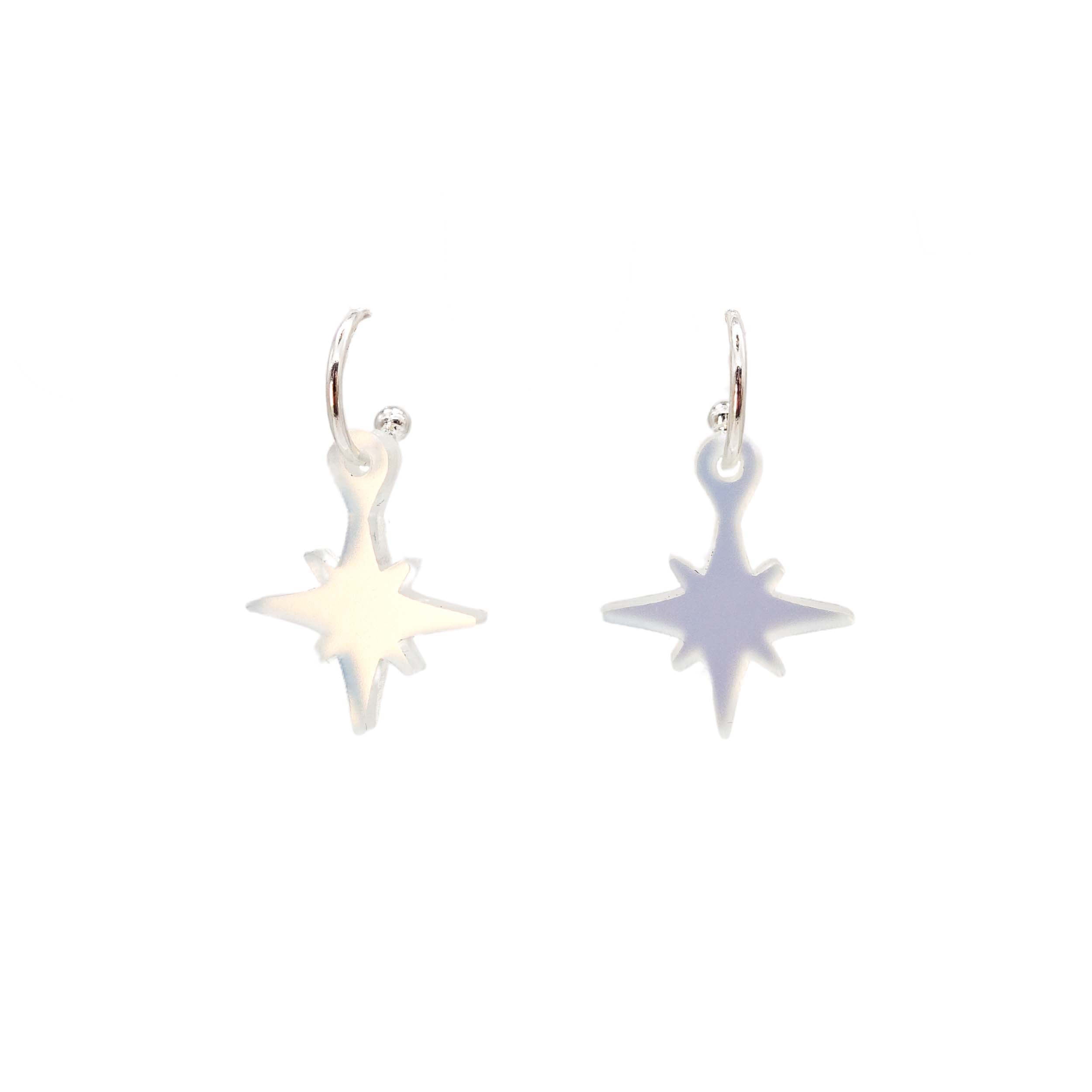 Neon vintage star earrings in matte iridescent shown on silver hoops against a white background.