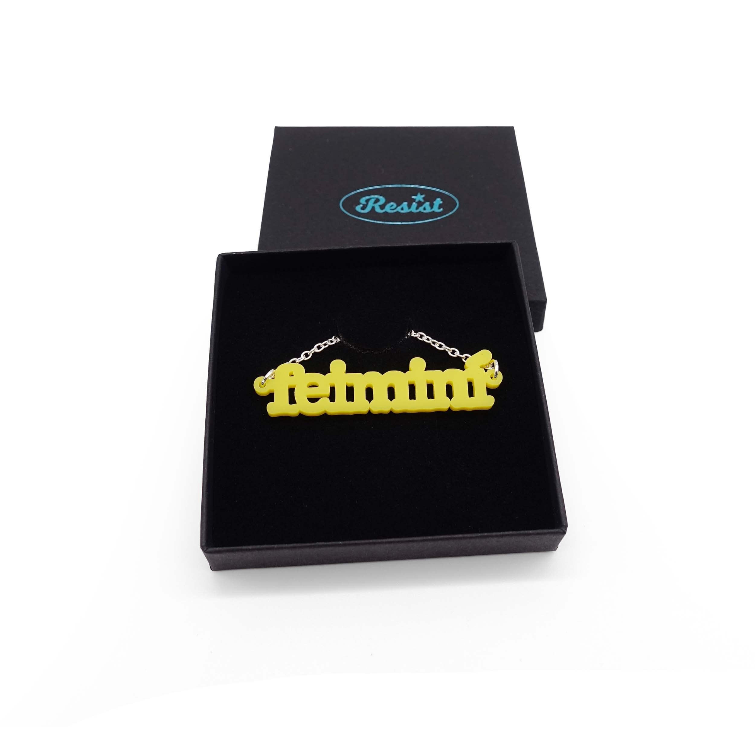 Irish Gaelic Feiminí necklace in matte lemon, shown in a Wear and Resist gift box.