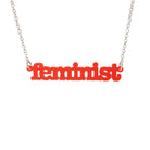 Matte red Feminist necklace shown hanging on a white background.