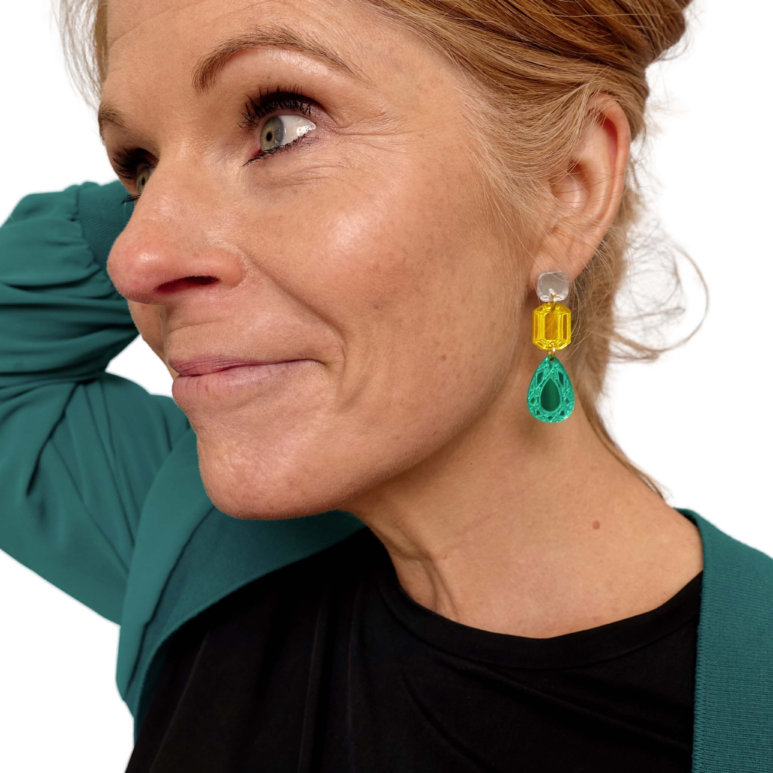 Sarah Day, founder of Wear and Resist wears medium jewel Belle Epoque earrings in yellow and electric green.