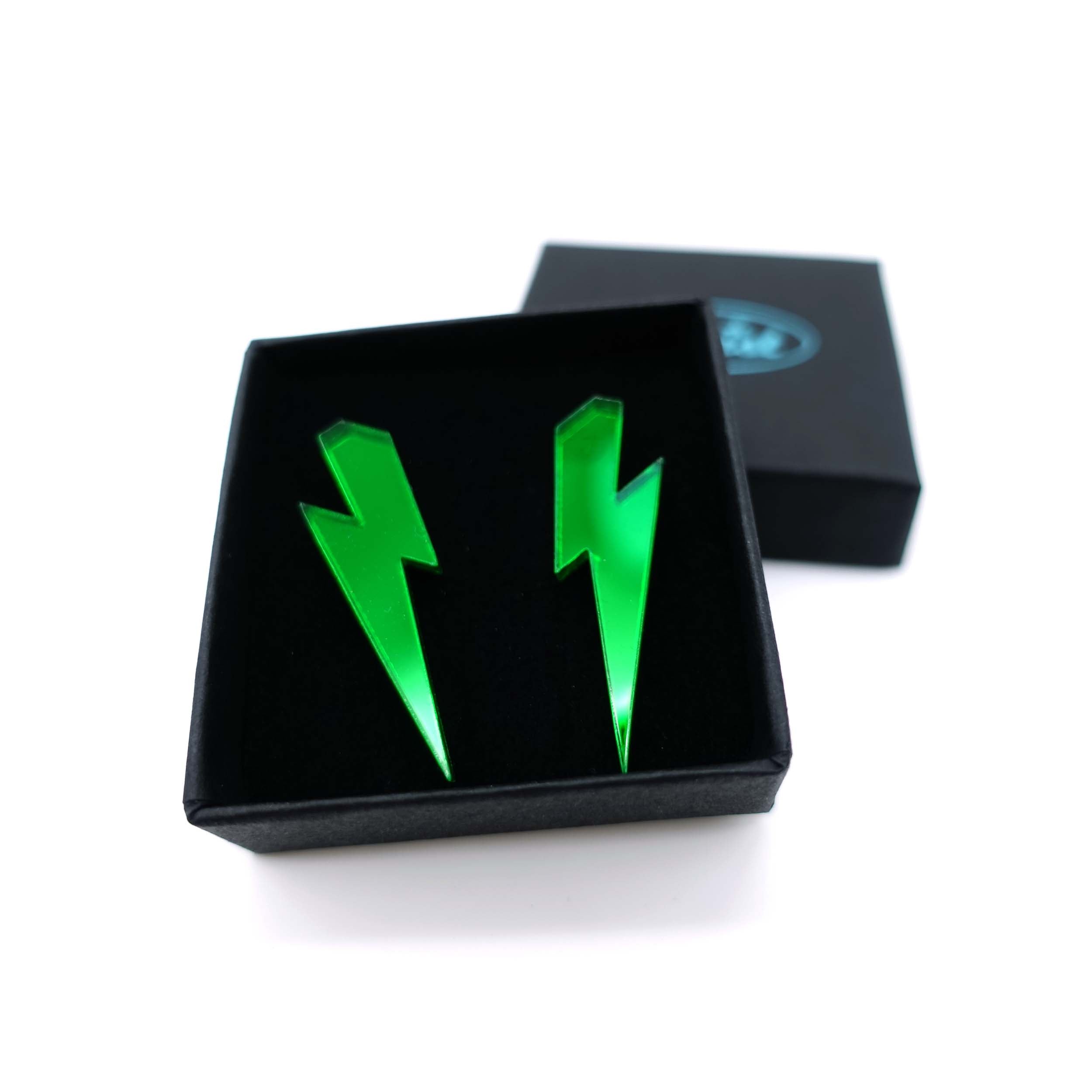 Medium Lightning Bolt earrings in envy green mirror, shown in a small Wear and Resist gift box.