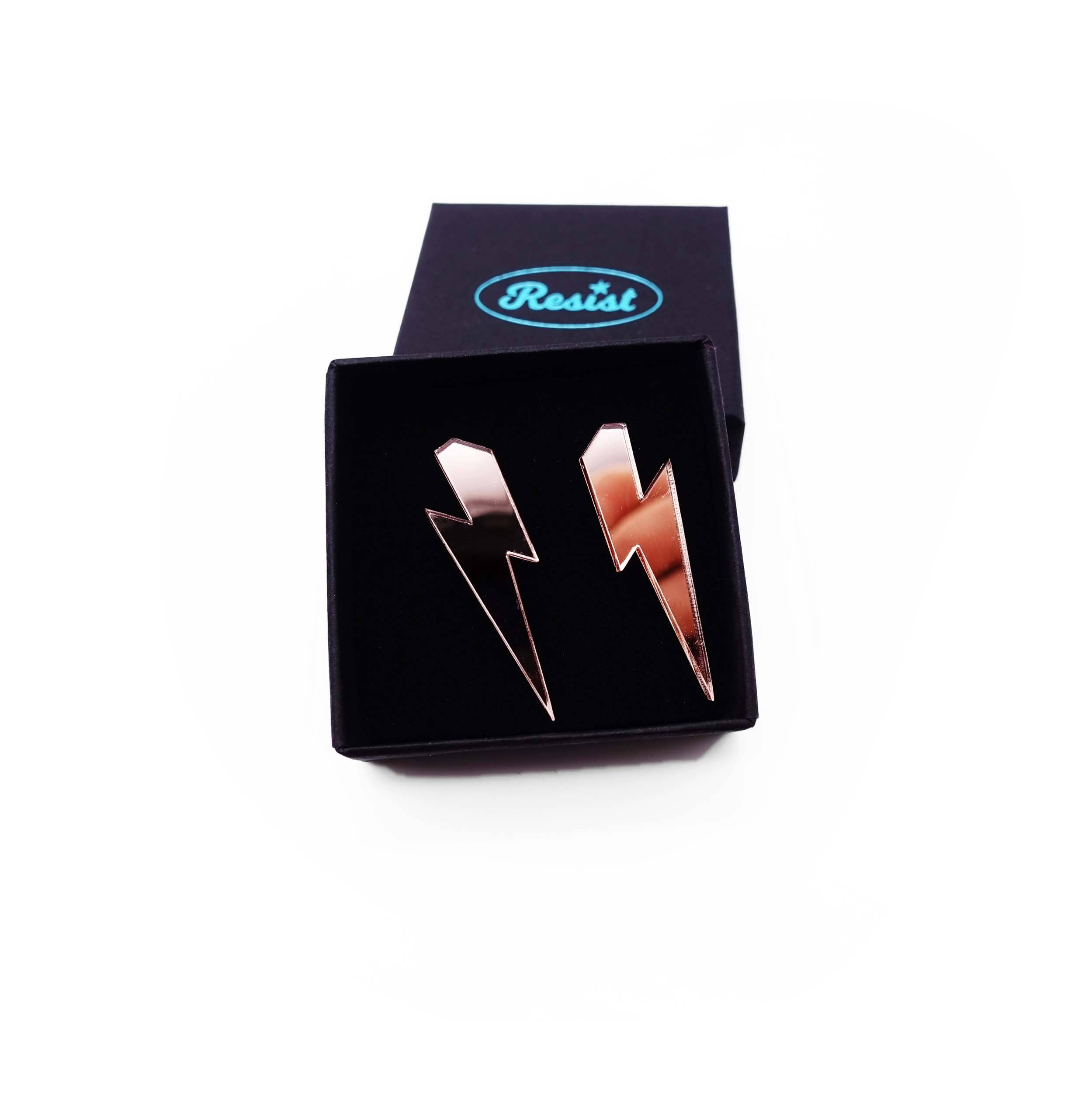 Medium Lightning Bolt earrings in rose gold mirror, shown in a small Wear and Resist gift box.