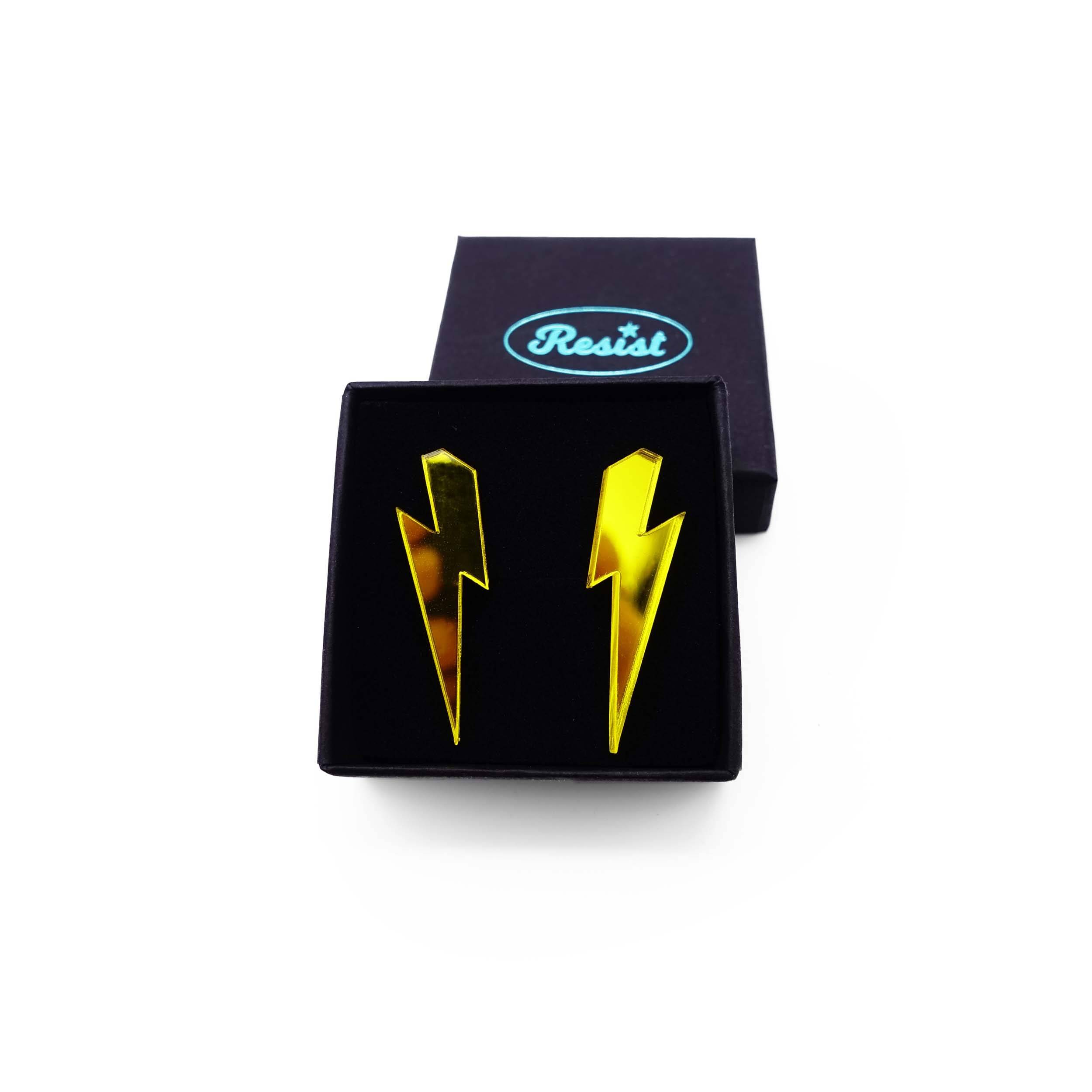 Medium Lightning Bolt earrings in yellow mirror, shown in a Wear and Resist gift box.
