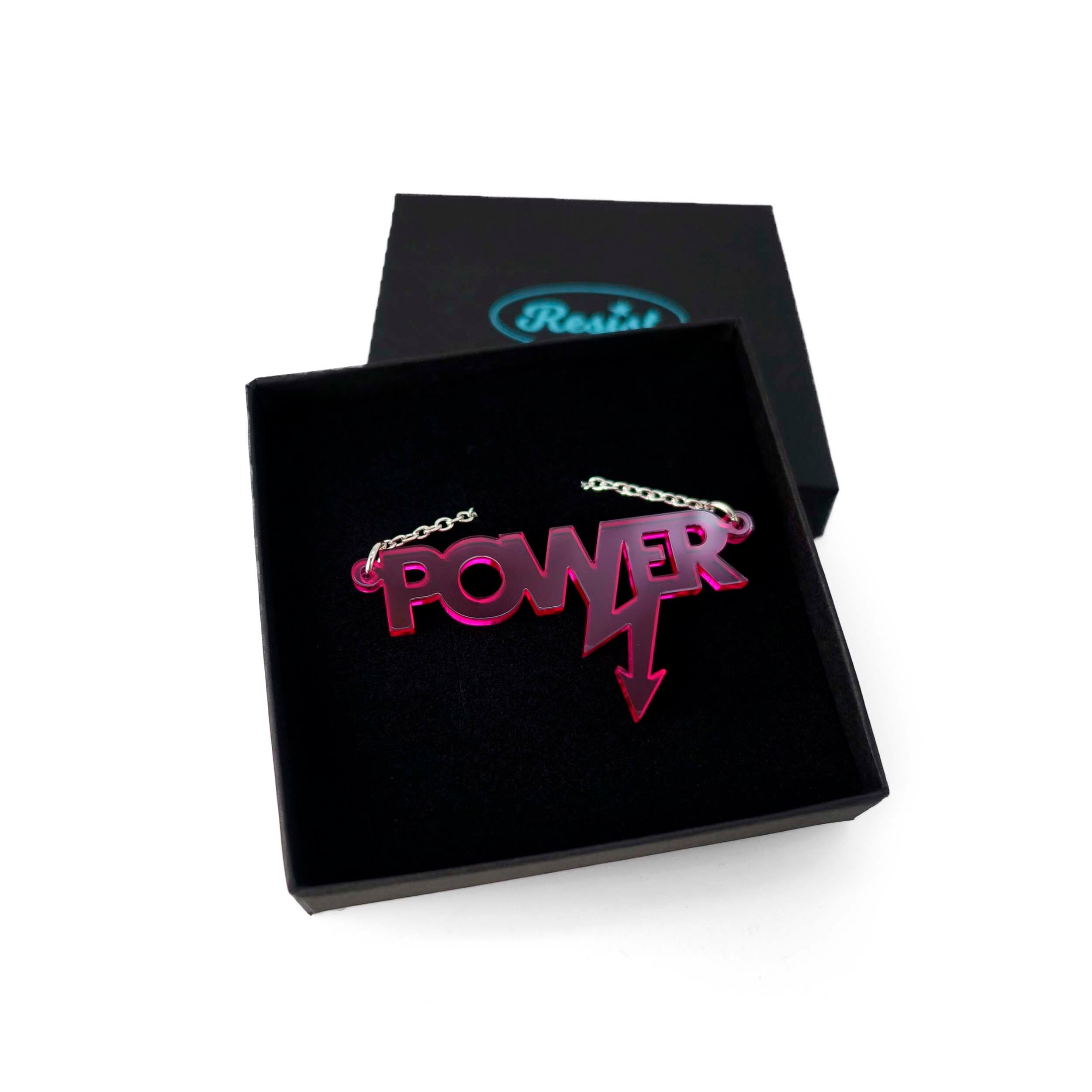 Mini power necklace in neon pink shown in a Wear and Resist gift box.