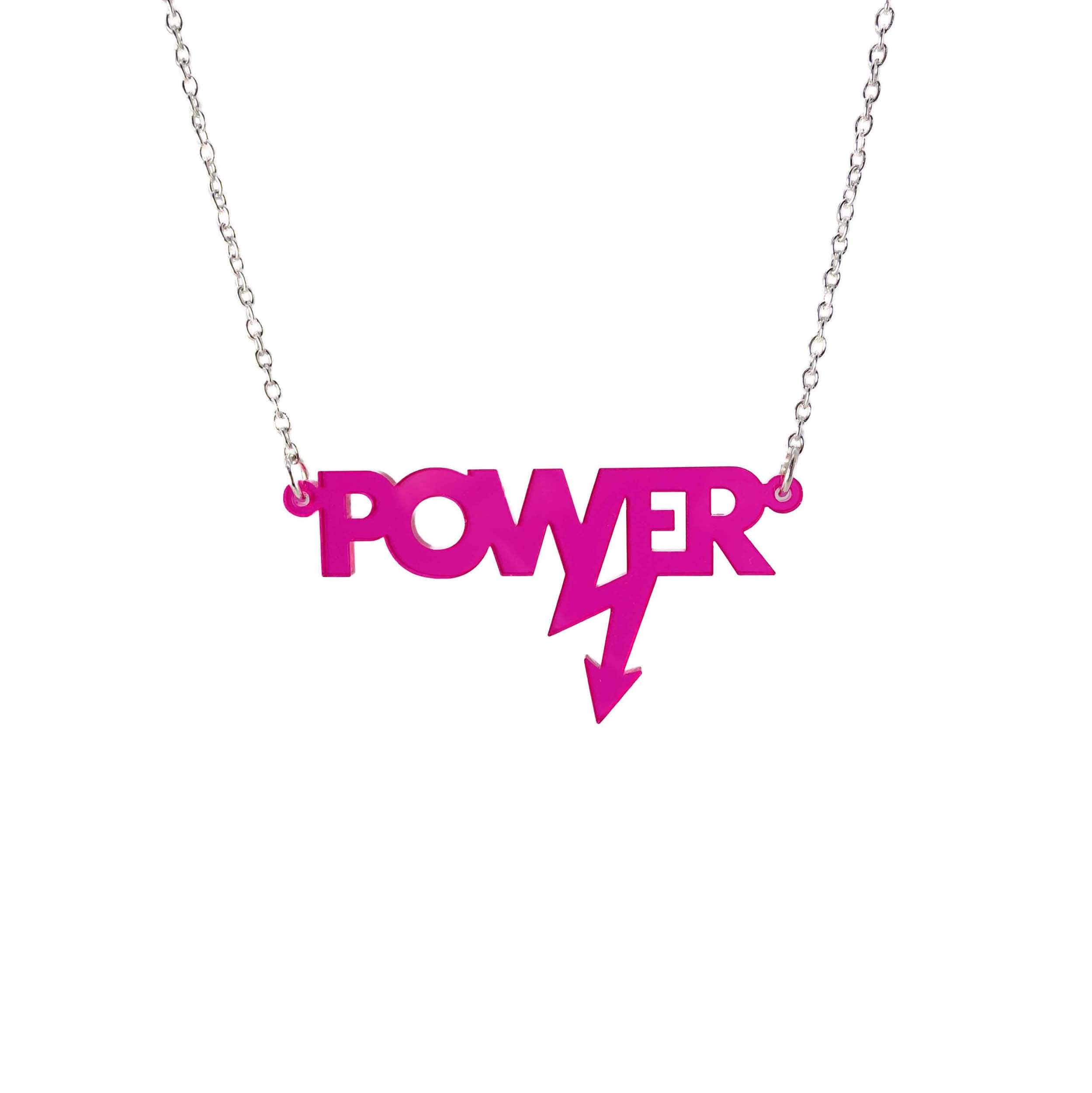 Mini power necklace in neon pink shown hanging on a silver chain against a white background. Designed in collaboration with Mary Beard for her book Women and Power.