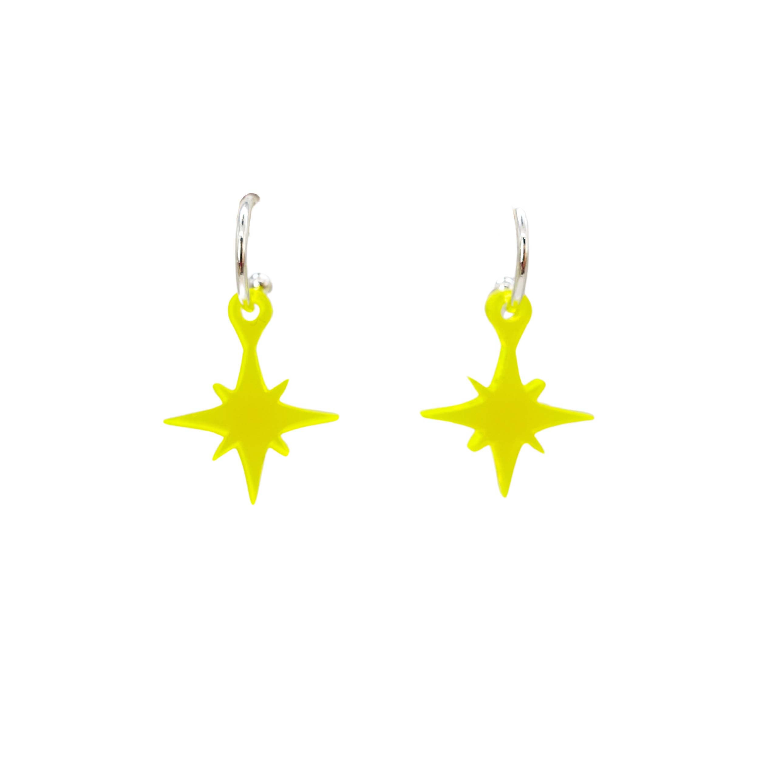 Vintage star earrings in neon yellow shown on silver hoops against a white background.