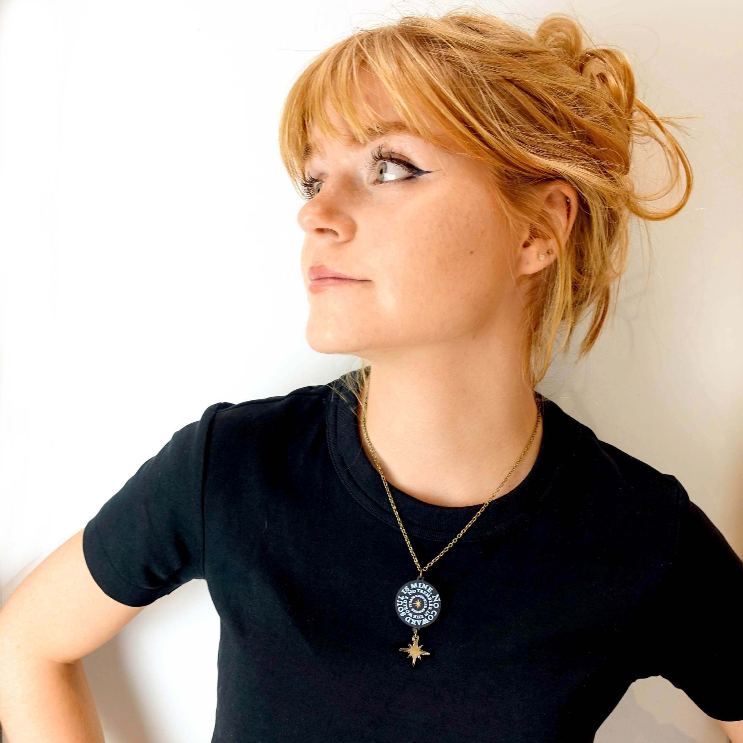 Eliza wears No Coward Soul is Mine pendant necklace from The Brontë Collection, designed by Sarah Day for Wear and Resist.