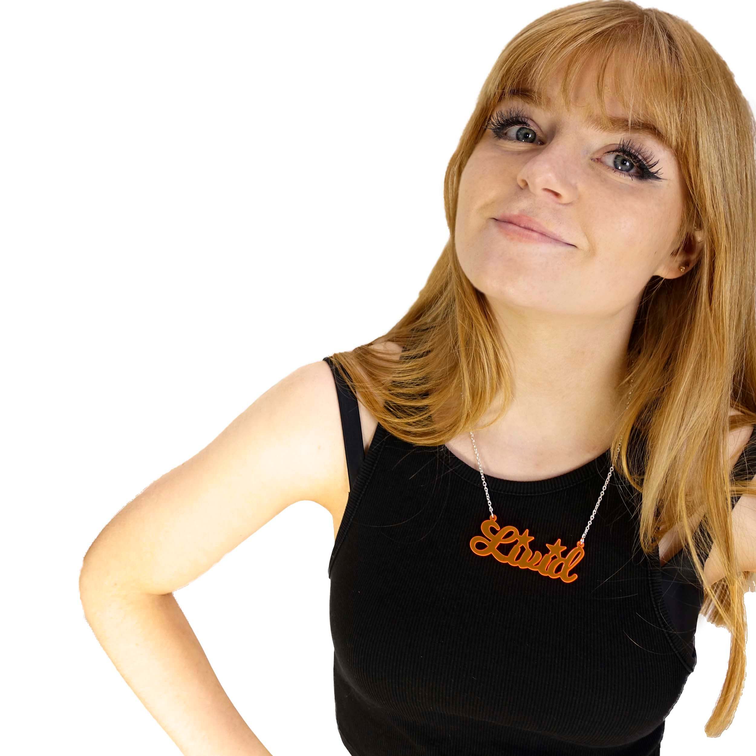 Eliza wears an orange Livid necklace.