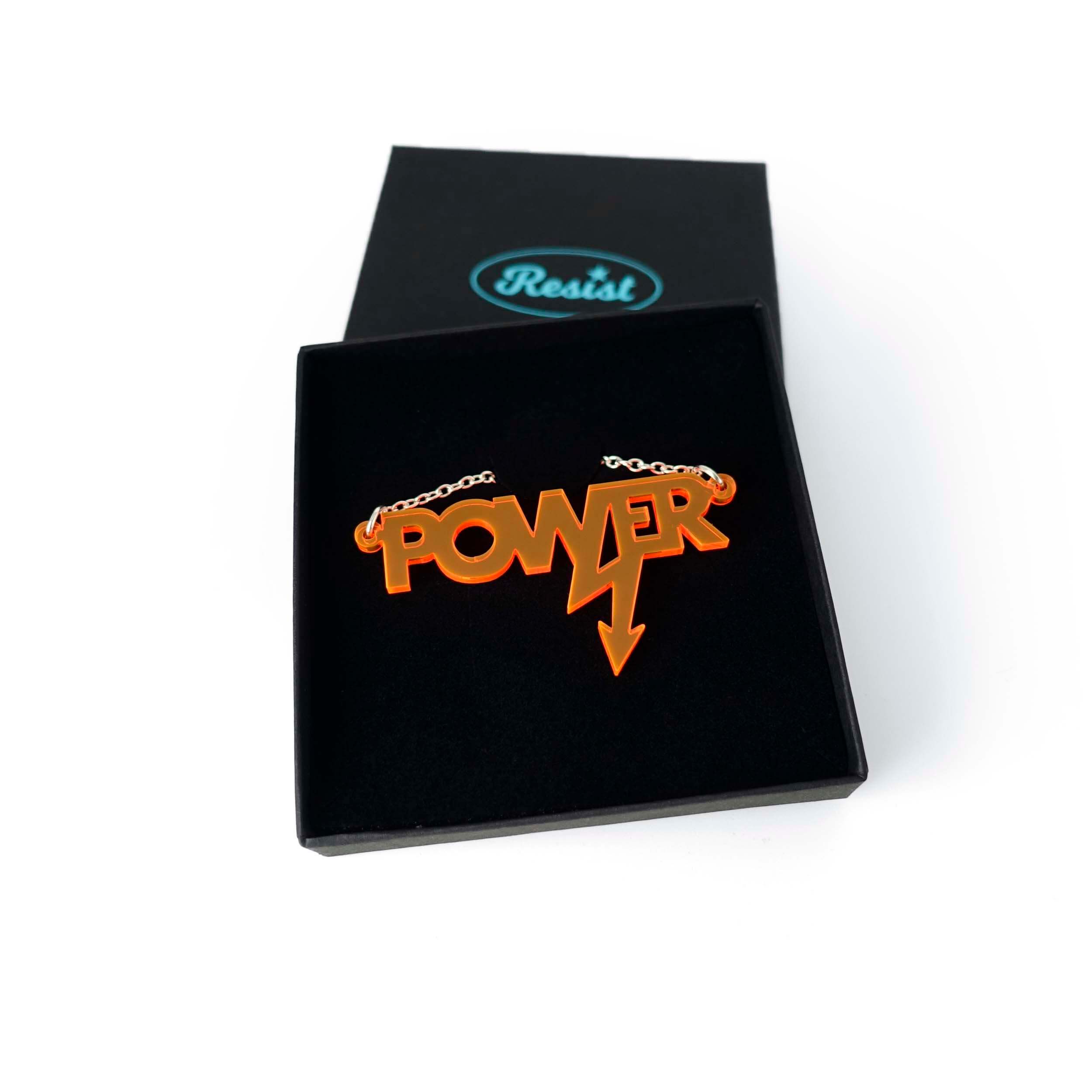 Mini power necklace in fluoro orange shown in a Wear and Resist gift box.