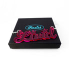 Livid necklace in neon pink shown on a Wear and Resist gift box.