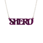 Purple glitter Shero necklace shown in a Wear and Resist gift box.