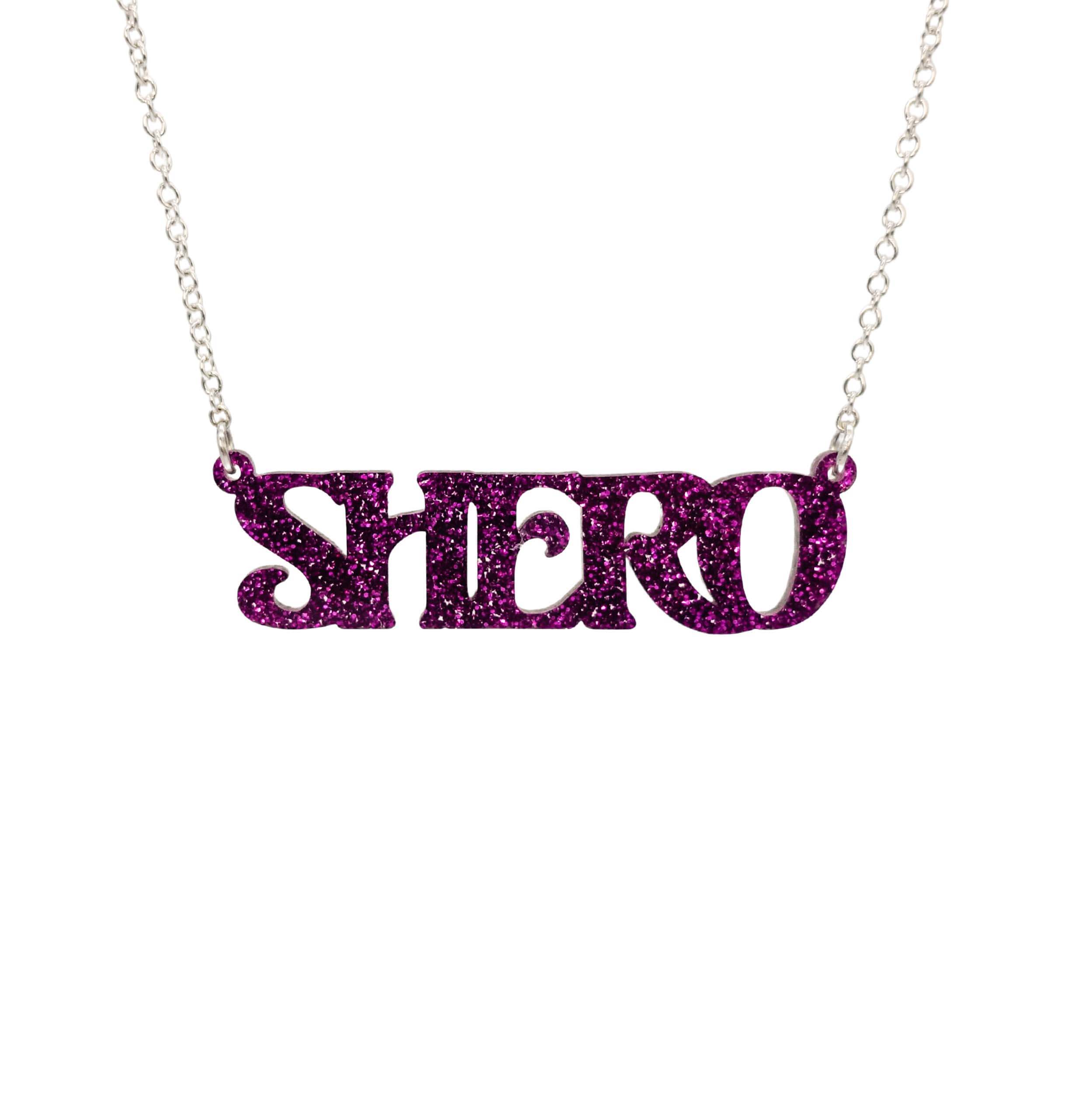 Purple glitter Shero necklace shown in a Wear and Resist gift box.
