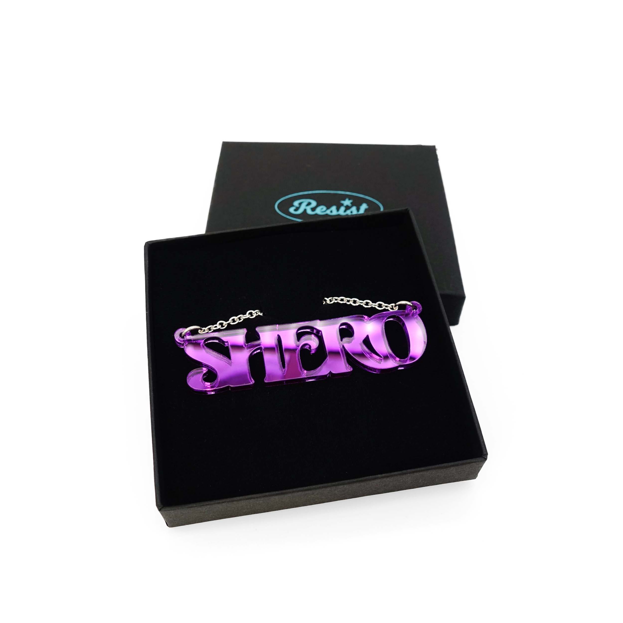 Purple mirror Shero necklace shown in a Wear and Resist gift box.