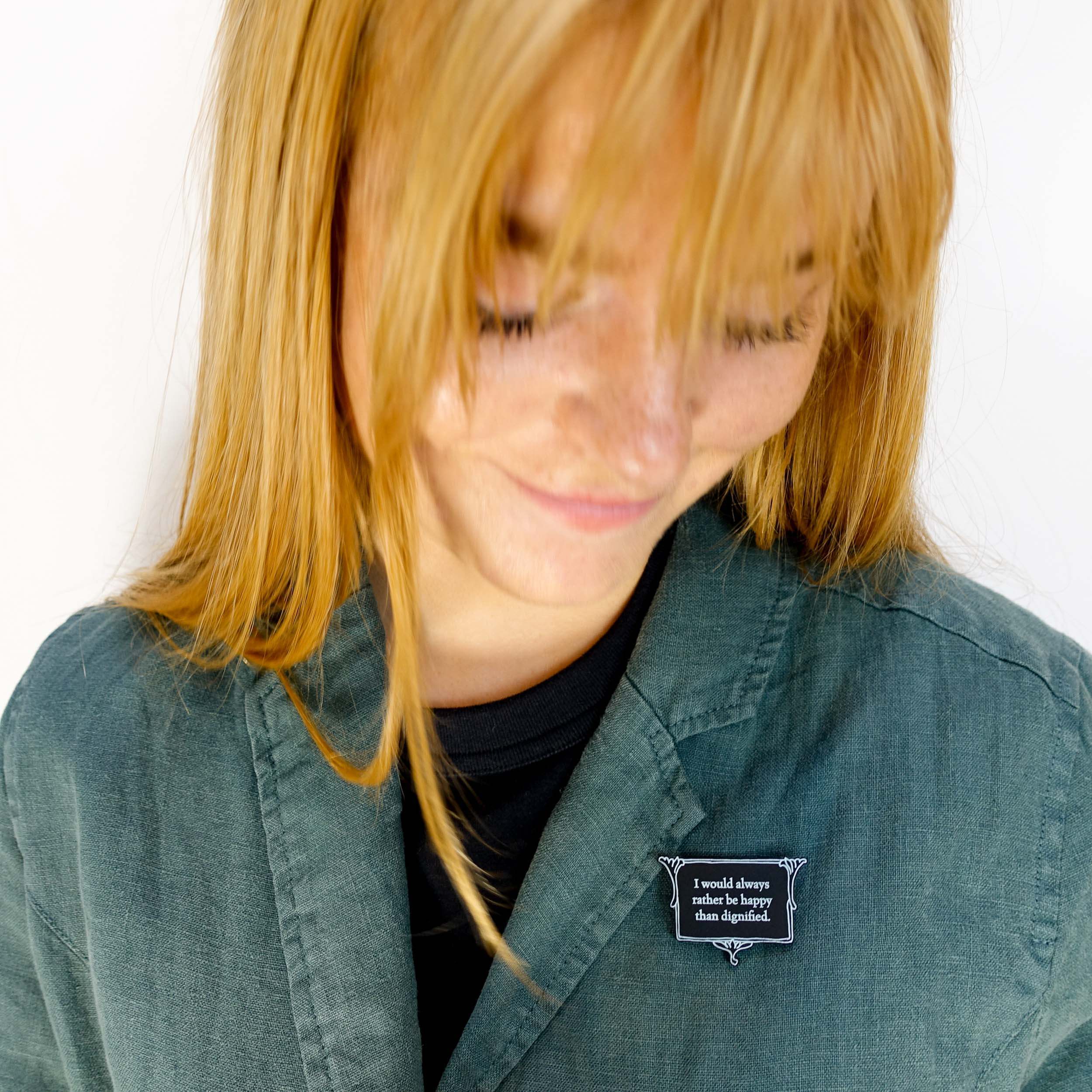 Eliza wears a brooch etched with glow-in-the-dark pigment with a quote fro Jane Eyre: 'I would always rather be happy than dignified.'