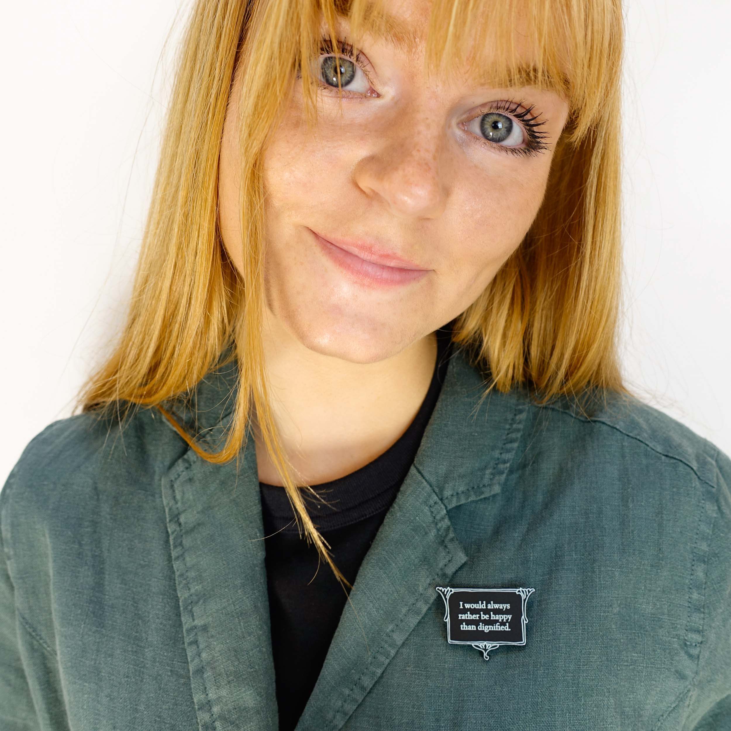 Eliza wears I'd always rather be happy than dignified brooch from the Bronte Collection, designed by Sarah Day for Wear and Resist in collaboration with the Bronte Parsonage Museum.