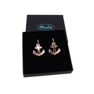 Medium anchor earrings in rose gold mirror etched with the words 'courage' on one and 'hold fast' on the other. Shown in a Wear and Resist gift box.